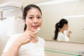 Young mother holding toothbrush face to camera