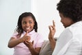 Deaf Mother Talking Sign Language With Her Daughter