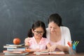 Mother teaching lovely preschool girl studying Royalty Free Stock Photo