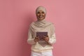 Smiling Muslim Woman With Digital Tablet In Hands Posing Over Pink Background Royalty Free Stock Photo