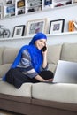 Smiling young Muslim woman using her laptop computer. Work from home Royalty Free Stock Photo