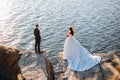 Smiling young newly married wedding couple on walk in rocky cliff Royalty Free Stock Photo