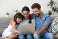 Smiling parents with kid watch funny movie on laptop Royalty Free Stock Photo