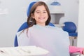 Smiling Young Patient Sitting In Dentists Chair