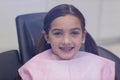 Smiling Young Patient Sitting On Dentists Chair