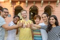 Smiling young people giving thumbs up sign Royalty Free Stock Photo