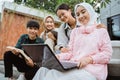 smiling young people working together on a laptop Royalty Free Stock Photo