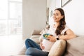 Smiling young pregnant woman having healthy breakfast Royalty Free Stock Photo