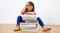 Smiling child sitting behind many books with a thumbs up Royalty Free Stock Photo