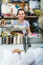 Smiling young professional female tailor using sewing machine Royalty Free Stock Photo