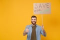 Smiling young protesting man guy hold protest sign broadsheet placard on stick showing thumb up isolated on yellow