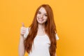 Smiling young redhead woman girl in white blank empty t-shirt posing isolated on yellow background studio portrait Royalty Free Stock Photo