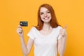 Smiling young redhead woman girl in white blank empty t-shirt posing isolated on yellow wall background in studio Royalty Free Stock Photo