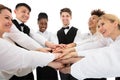 Smiling Young Restaurant Staff Stacking Hands Royalty Free Stock Photo