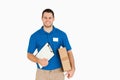 Smiling young salesman with parcel and clipboard