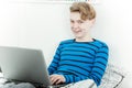 Smiling young schoolboy studying at home