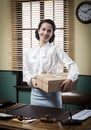 Smiling young secretary holding a mail package Royalty Free Stock Photo