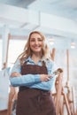 Young seller in uniform in the art store