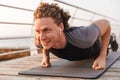 Smiling young sportsman in wireless earphones Royalty Free Stock Photo