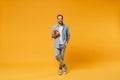 Smiling young student man in casual blue shirt posing isolated on yellow orange wall background studio portrait. People Royalty Free Stock Photo