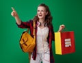 Student woman with shopping bag with books pointing at something Royalty Free Stock Photo