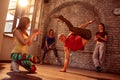 Smiling stylish male break dancer performing moves Royalty Free Stock Photo