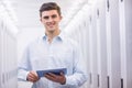 Smiling young technician working with his tablet Royalty Free Stock Photo