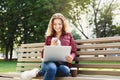 Smiling young texting on smartphone outdoors