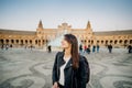 Smiling young tourist woman posing at Plaza de Espana in, Seville Sevilla, Andalusia, Spain.Traveling to Spain.Sunset on Spain