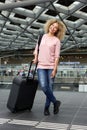 Smiling young travel woman waiting at the station