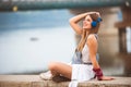 Smiling young urban woman using smart phone outdoors while waiting for her friends Royalty Free Stock Photo