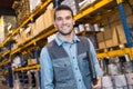 smiling young warehouse worker in red uniform copy space Royalty Free Stock Photo