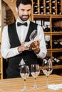 smiling young wine steward checking clean glass