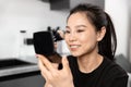 Smiling Young Woman Applying Makeup with Brush Mirror Royalty Free Stock Photo