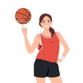 Smiling young woman athlete spin ball on finger. Happy girl basketball player play with ball. Sport and game activity Royalty Free Stock Photo