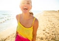 Smiling young woman on beach in evening having fun time Royalty Free Stock Photo