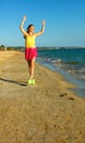 Smiling young woman on beach in evening having fun time Royalty Free Stock Photo