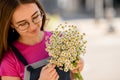 smiling young woman with bouquet of fresh white small daisies in her hands Royalty Free Stock Photo