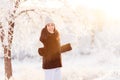 Smiling young woman brunette winter day in the snowy forest. beautiful frost in the trees