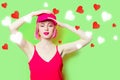 Smiling young woman in cap with hearts Royalty Free Stock Photo