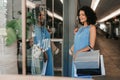 Smiling young woman window shopping in a mall Royalty Free Stock Photo