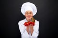 Smiling young woman chef with tomatos juggle Royalty Free Stock Photo