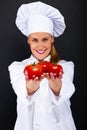 Smiling young woman chef with tomatos juggle Royalty Free Stock Photo