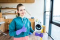 smiling young woman cleaning house with mop and showing Royalty Free Stock Photo