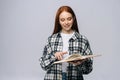 Smiling young woman college student turning pages of book while reading. Royalty Free Stock Photo