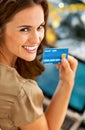 Smiling young woman with credit card using laptop in Royalty Free Stock Photo