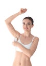 Smiling young woman doing armpit epilation procedure on white