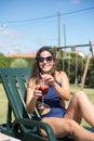 Smiling young woman drinking bright cocktail Royalty Free Stock Photo