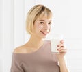 Smiling young woman drinking milk Royalty Free Stock Photo