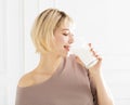 Smiling young woman drinking milk Royalty Free Stock Photo